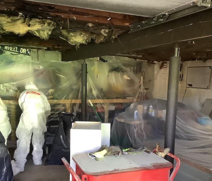 SERVPRO technicians cleaning up fire damage in a garage 