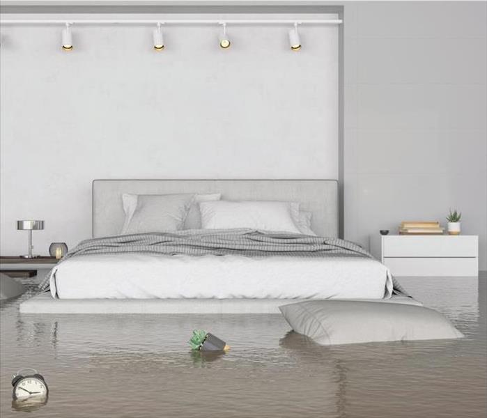 flooded bedroom with white bed and end tables